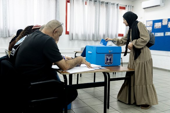 An Arab-Israeli woman casts her ballot during Israel’s general elections in Umm El Fahem, Israel. 