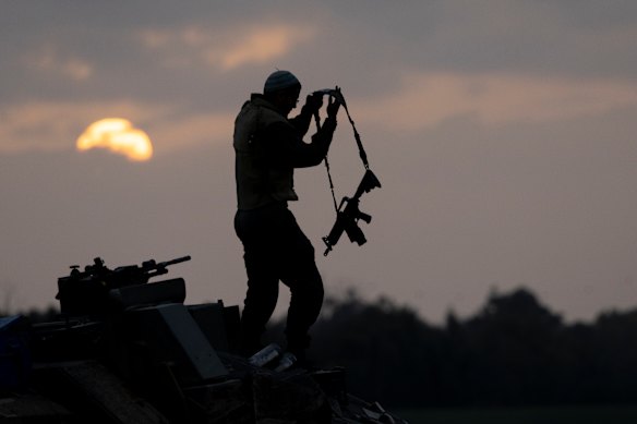 An Israeli soldier stands on a tank near the northern Gaza Strip.