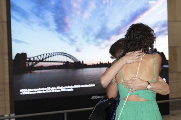 Amanda Moss hugs her mother  Cindy after more than three years apart as international arrivals resume. 