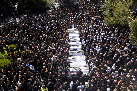 Mourners attend a funeral for ten of the victims of the rocket attack in Majdal Shams, Golan Heights.