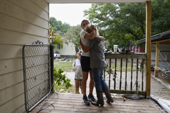 Ashlie Salliotte hugs Janet Sams at Sams’ flood-damaged home along River Road in Newport, Tennessee.