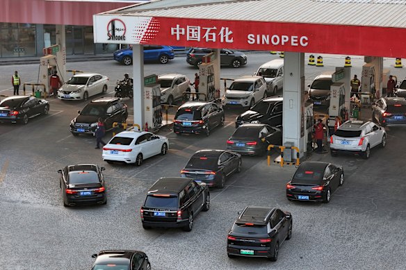 Cars line up at a petrol station in Yantai in eastern China’s Shandong province on Monday.
