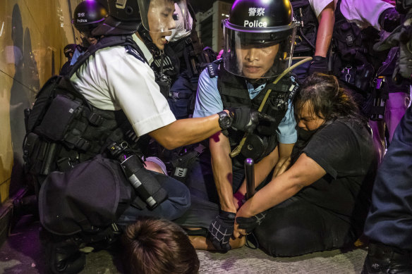 Police officers mark arrests in the Sha Tin district of Hong Kong, July 14, 2019
