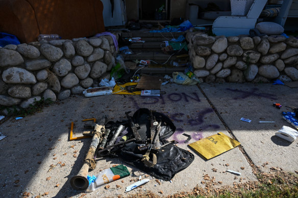 RPG launchers and other weapons are left outside a house for media to see, after Hamas militants attacked this kibbutz days earlier near the border of Gaza, on October 15 in Kfar Aza, Israel.