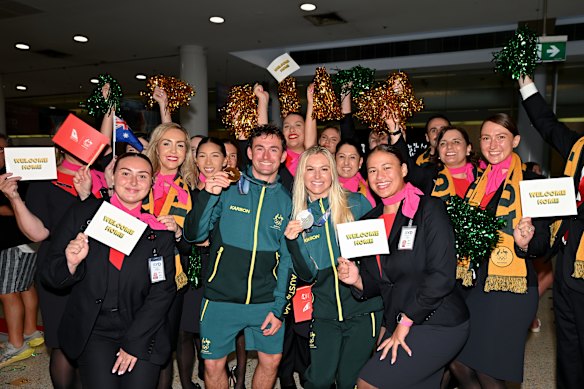 Cooper Woods and Danielle Scott with Qantas staff at Sydney Airport. 