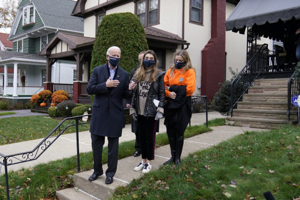 Democratic presidential candidate former Vice President Joe Biden speaks to reporters after he visited his childhood home in Scranton with his granddaughters Natalie, centre, and Finnegan.