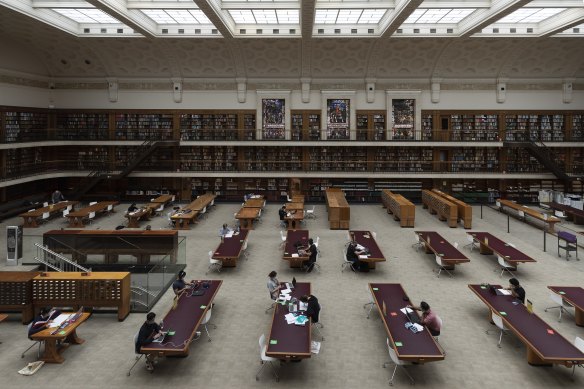 People work in the State Library of NSW as mask wearing becomes mandatory in certain indoor settings.