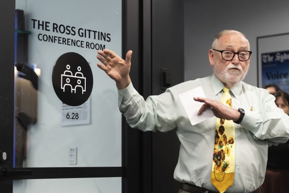 Ross Gittins speaks to staff outside the newly renamed conference room.