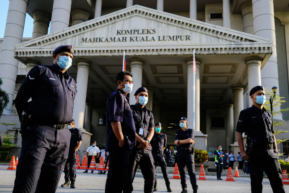 Police guard the entrance of the court complex in Kuala Lumpur on Tuesday.