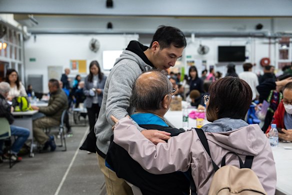Residents rest at a temporary shelter after a fire broke out at Wang Fuk Court, a residential estate in the Tai Po district of Hong Kong’s New Territories.