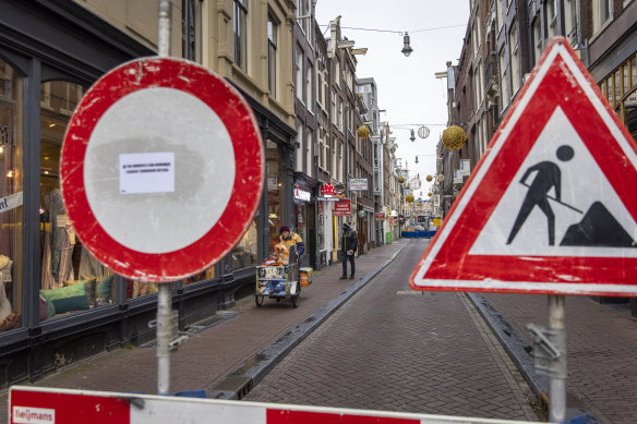 A street closed off because of construction work on the canal walls at loveniersburgwal in Amsterdam.