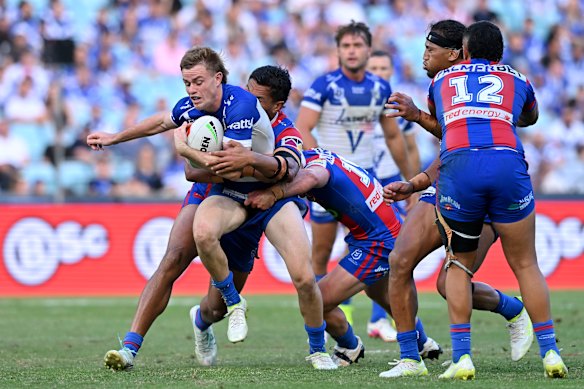 Lachlan Galvin is tackled by the Knights last weekend after one of his 28 runs in the game. 