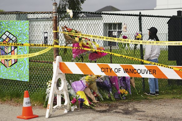 A member of Vancouver’s Filipino community visits a growing memorial near the festival site on Sunday.