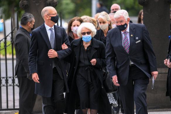 Shirely Gobbo (centre), the wife of the late Sir James Gobbo, is escorted into St Patrick’s Cathedral.