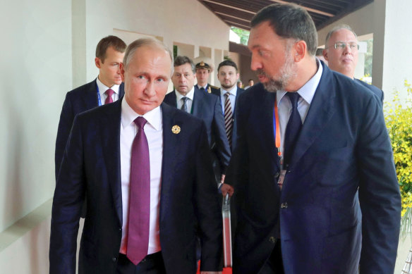 Russian President Vladimir Putin, left, and Russian metals magnate Oleg Deripaska, right - one of the few oligarchs who still has interests in Australia. 