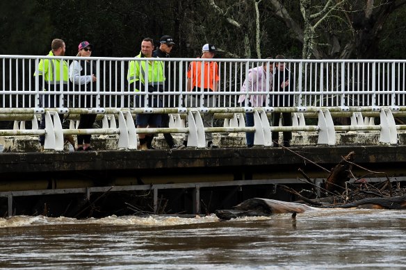 Debris piles up against the Cowpasture Bridge at Camden as the Nepean River rises.