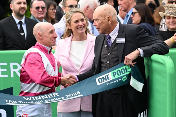 Jockey Willie Pike and trainer Andrea Leek were congratulated by owner Bob Peters (right) after Cosmic Crusader’s win.