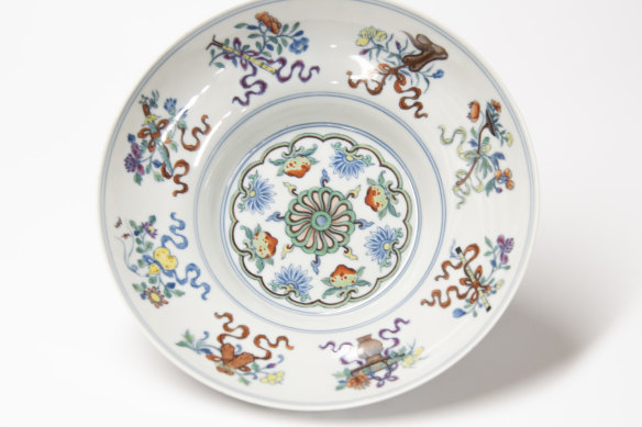 Wucai decoration on porcelain from the Qing Dynasty showing symbols of the eight Taoist Immortals. Once owned by Sir Keith Murdoch, the piece was bequeathed by his friends, Herbert and May Shaw, to the Hamilton Gallery.