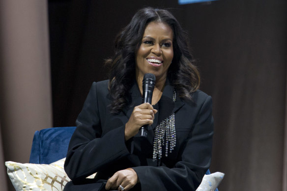 Michelle Obama  wearing a black crystal-embellished suit by Christopher Kane.