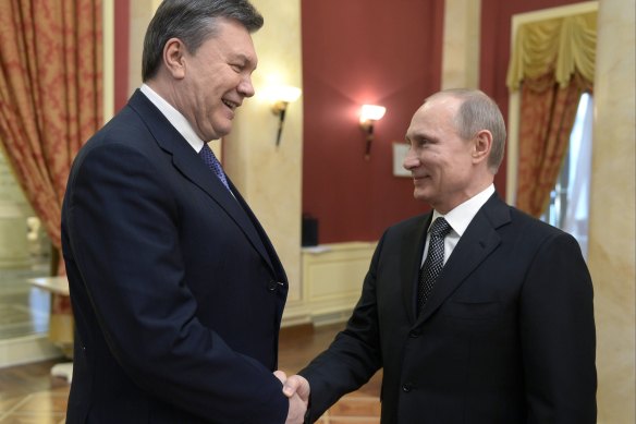 Vladimir Putin, right, with ousted Ukrainian president Viktor Yanukovych, who is now living in exile in Russia.