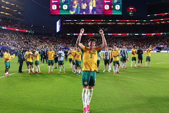 Jordan Bos and the Socceroos celebrate after their draw with Paraguay secured a place in the World Cup knockout stage.