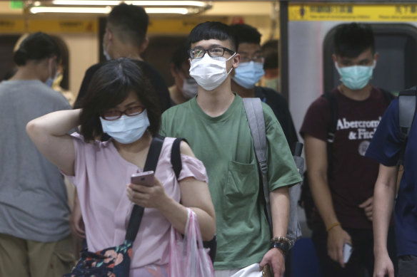 People wear face masks as they ride the subway in Taipei, Taiwan.