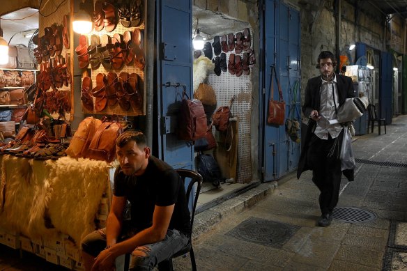 An ultra-Orthodox Jew walks through the streets of the Old City during the evening in Jerusalem.