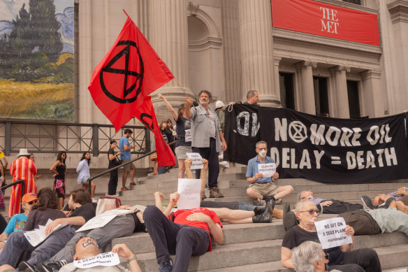 Climate activists demonstrate outside the Metropolitan Museum.