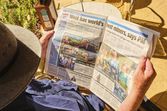 A man reads The West Australian at Dome Cafe, Midland in the seat of Hasluck.
