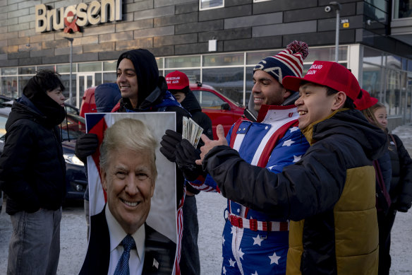 A group of pro-Trump social media influencers called the Nelk Boys give out red MAGA hats and $US100 bills in Nuuk, Greenland in January.