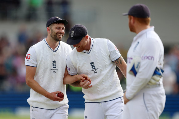 England’s Mark Wood celebrates with Ben Stokes after taking the wicket of Australia’s Todd Murphy to complete the Australian innings.