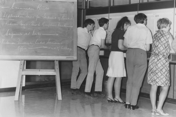 Students check their matriculation results on the boards placed at the Melbourne offices of the Victorian Universities and Schools Examination Board in 1967.
