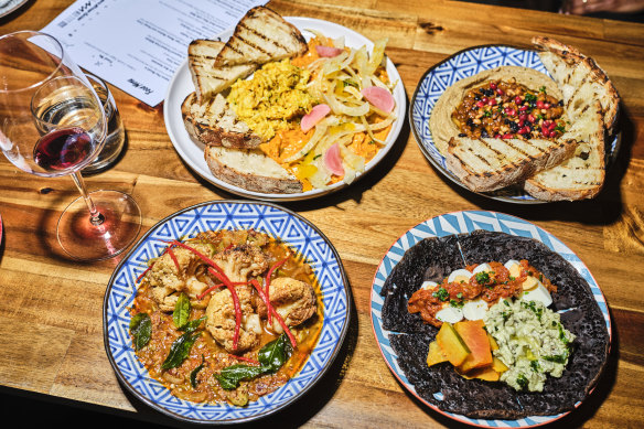 South African Cape Malay beef curry is served on a hillock of thick hummus and strewn with pomegranate, currants and pine nuts (top right dish). 
