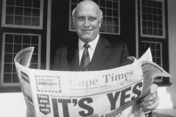 Then South African president F.W. de Klerk outside his office in Cape Town in 1992, holding a newspaper declaring a “Yes” result in the referendum to end apartheid and share power with the black majority for the first time.