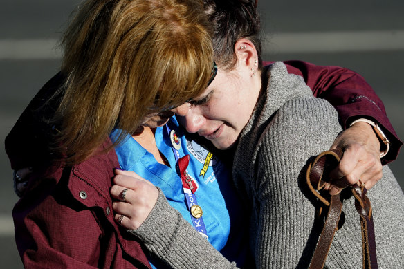 A couple hug near the site of a weekend mass shooting at a gay bar, in Colorado Springs, Colorado.