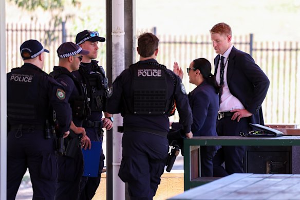 Detectives and officers at the site of the stabbing in Rouse Hill.