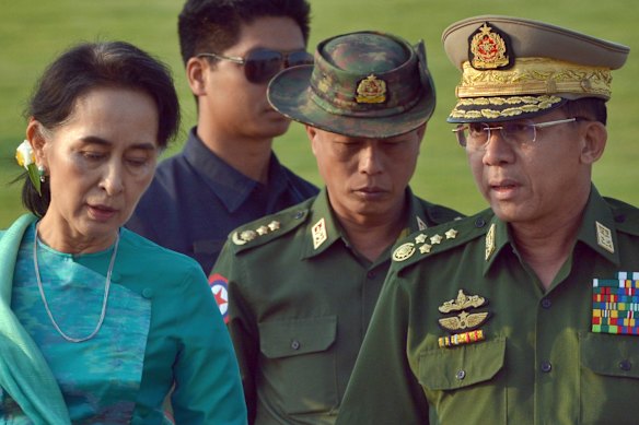 Aung San Suu Kyi, left, Myanmar’s then foreign minister, walks with Senior General Min Aung Hlaing, right, in 2016