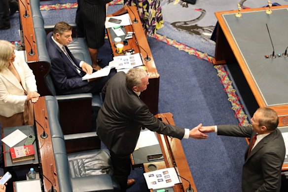 Roger Cook shakes Shane Love’s hand.