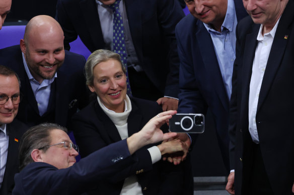 Smiling leading members of the far-right Alternative for Germany (AfD), including AfD chancellor candidate Alice Weidel, shoot a selfie at the Bundestag.