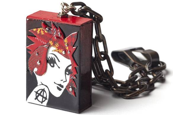 Riot Grrrl has undergone an upcycling makeover with tartan hair and a sterling-silver chain.