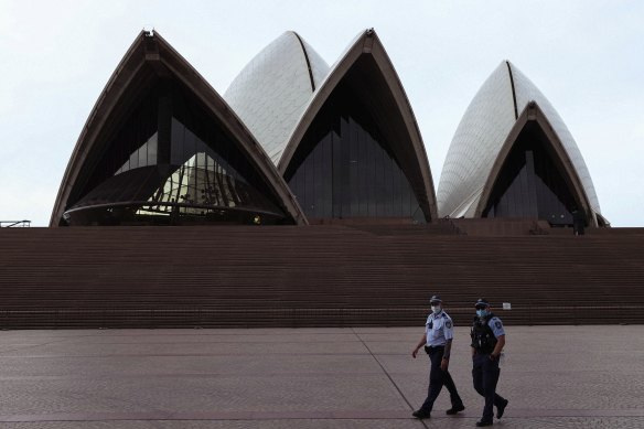 Police patrol around the Sydney Opera House as mask-wearing outside became mandatory across NSW during a COVID-19 lockdown in Sydney on August 23, 2021.