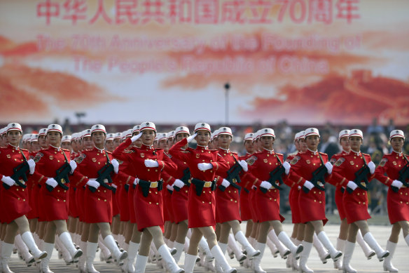 Chinese female militia members march in formation during a parade to commemorate the 70th anniversary of the founding of Communist China in Beijing.