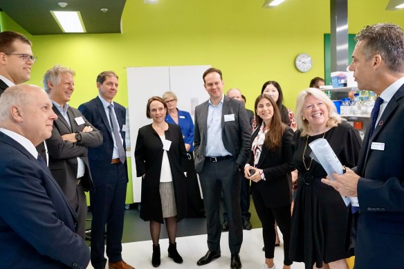 Treasurer Tim Pallas (left) and Medical Research Minister Jaala Pulford (centre) with BioNTech chief operations officer  Sierk Poetting (third from left) and others at the BioNTech facility in Melbourne on Friday.
