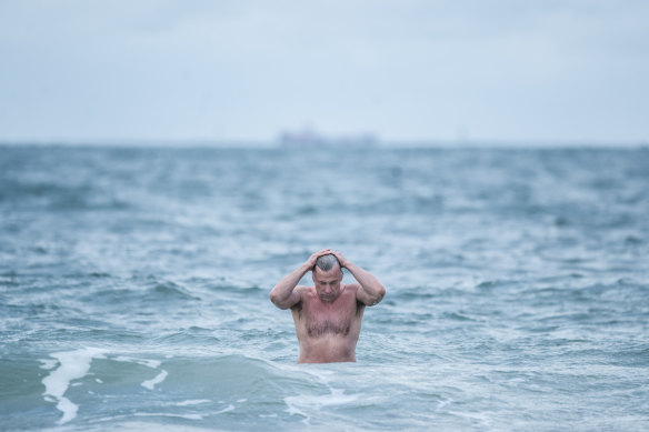 Brrr: Peter Brydon went for a dip at Middle Park beach on Friday morning. 