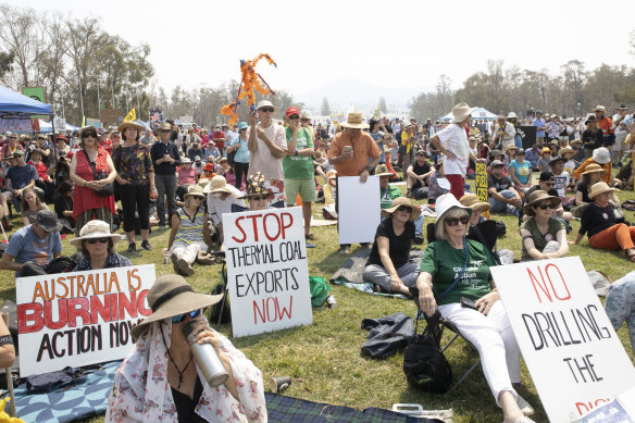 People rallying outside Parliament House on Tuesday listen to new Greens leader Adam Bandt speak. 