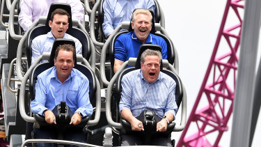 Queensland Opposition Leader Tim Nicholls (bottom right) takes a ride on the DC Rivals Hypercoaster at the Movie World theme park on the Gold Coast.