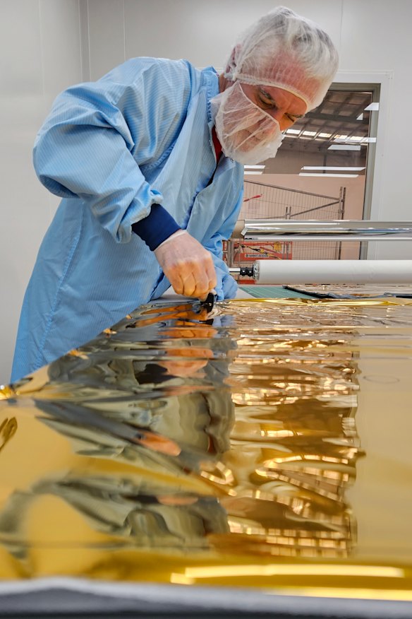 Industrial sewing machinist Philippe Vincent working on the multi-layer insulation blanket.