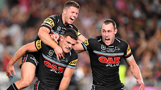 Nathan Cleary of the Panthers celebrates with teammates after scoring the match-winning try.