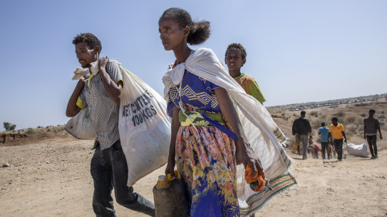 Tigray refugees who fled the conflict walk arrive on the banks of the Tekeze River on the Sudan-Ethiopia border.