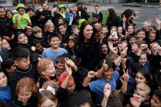 The prime minister surrounded by adoring fans in an Auckland schoolyard.